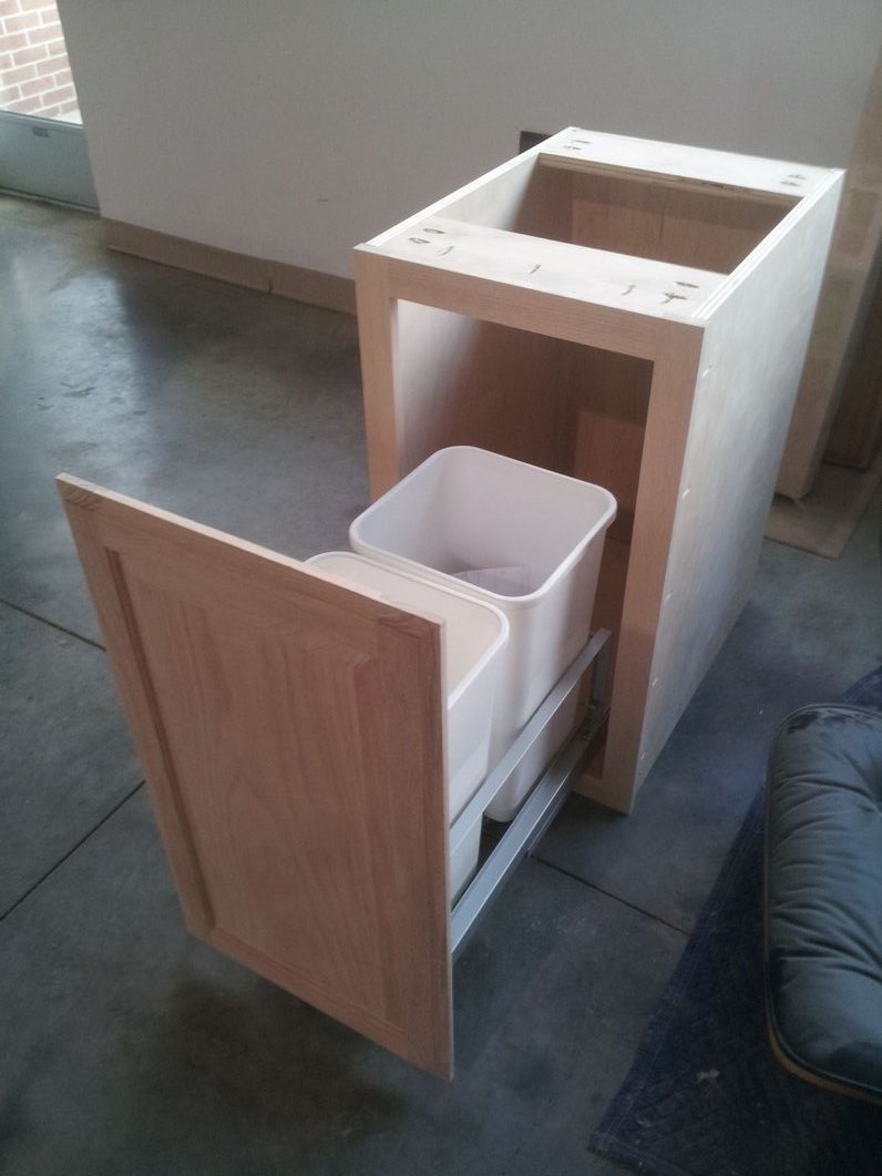 Trash pull-out cabinet.